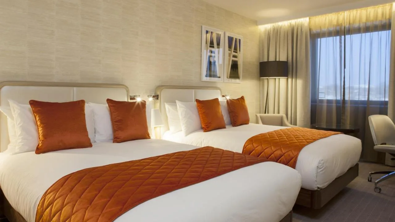 a hotel room with two beds and a window at Crowne Plaza London Kings Cross by IHG in London